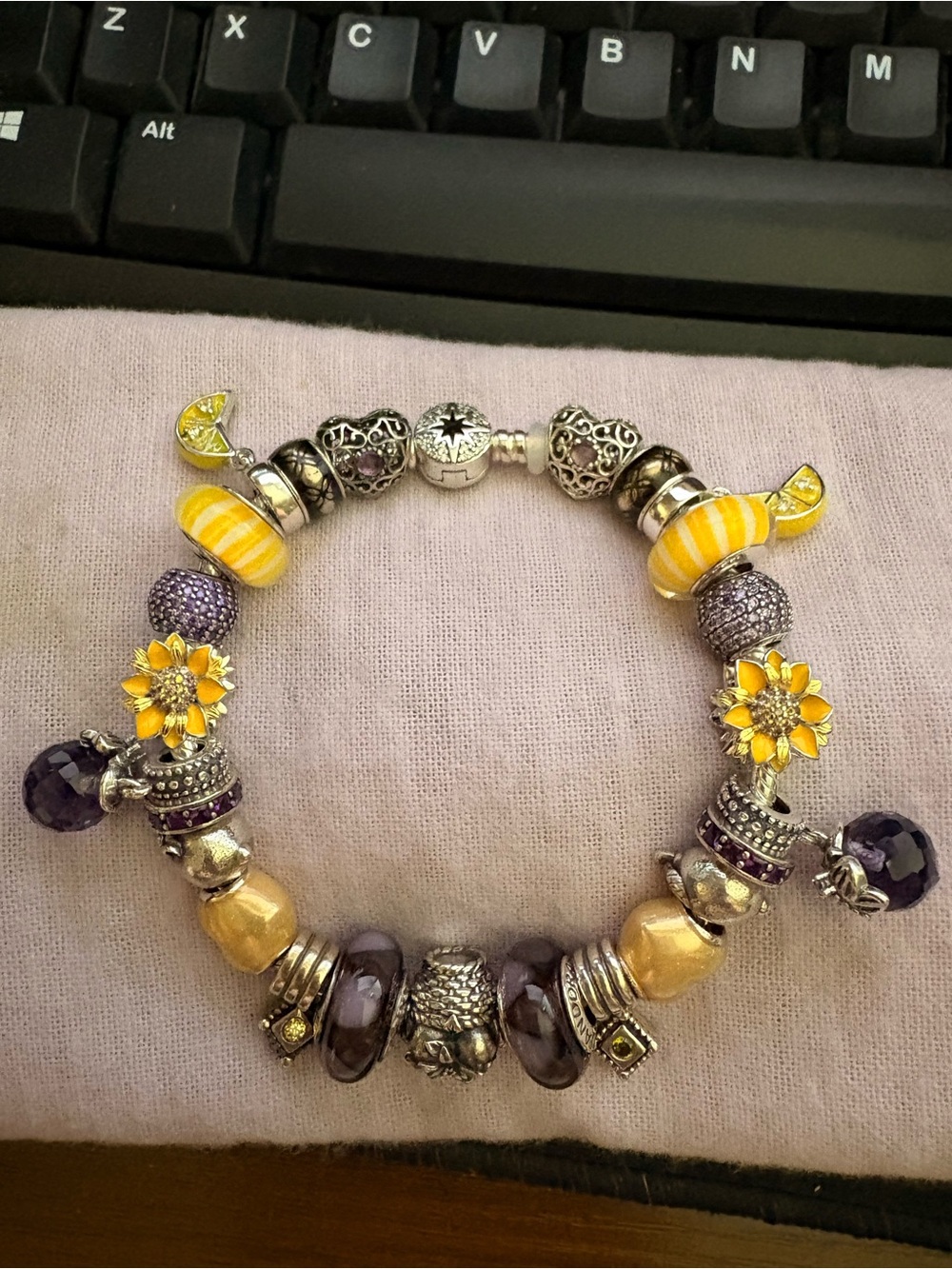 Pandora bracelet with purple and yellow theme charms
